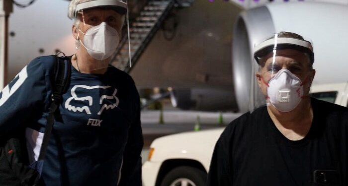 Canadian director James Cameron (L) and U.S. producer Jon Landau pose for a photo, while arriving at Wellington International Airport to resume the filming of the Avatar sequels, as New Zealand eases restrictions imposed over the global outbreak of the coronavirus disease (COVID-19), in Wellington, New Zealand, May 31, 2020, in this image obtained from social media. Courtesy of Lightstorm Entertainment/Social Media via REUTERS. ATTENTION EDITORS - THIS IMAGE HAS BEEN SUPPLIED BY A THIRD PARTY. MANDATORY CREDIT LIGHTSTORM ENTERTAINMENT. NO RESALES. NO ARCHIVES.