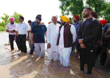 CM inspecting the water logged fields