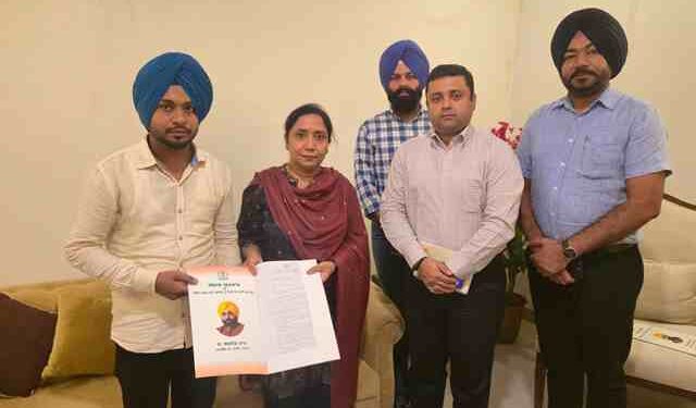 Dr. Baljit Kaur hands over appointment letters to two newly appointed employees of the Social Security Department